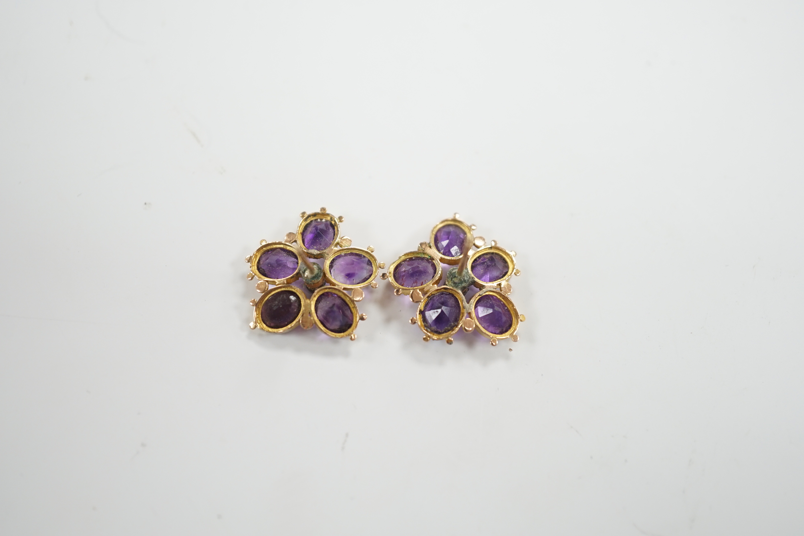 A pair of yellow metal, amethyst and seed pearl set flowerhead ear studs, 18mm, gross weight 4 grams.